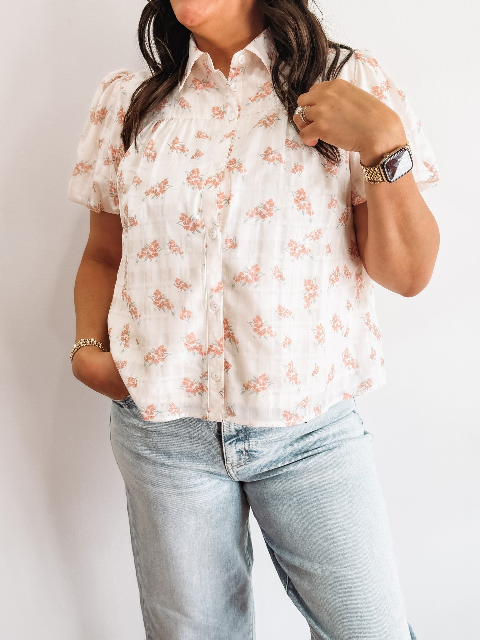 White button up blouse with pink floral detailing.