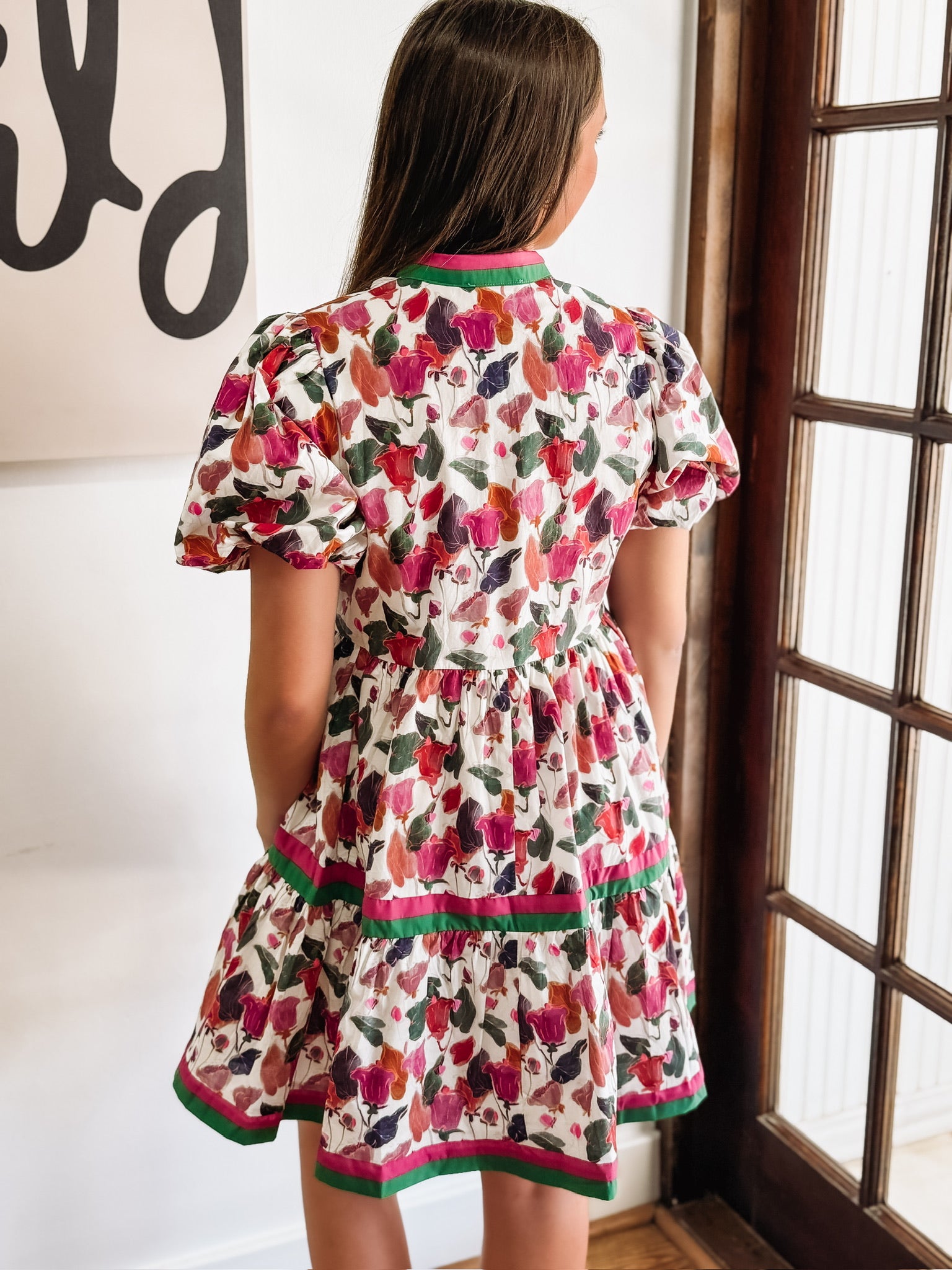 Green, Wine, Purple, Pink and Orange floral mini dress with puff sleeves and pink and green contrast seaming.