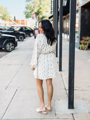 Yellow floral on a cream base long sleeve  tie waist long sleeve mini dress.