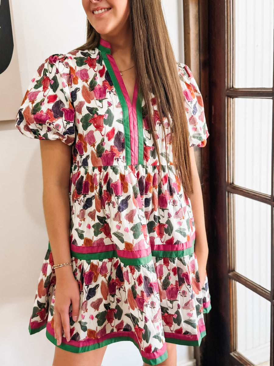 Green, Wine, Purple, Pink and Orange floral mini dress with puff sleeves and pink and green contrast seaming.