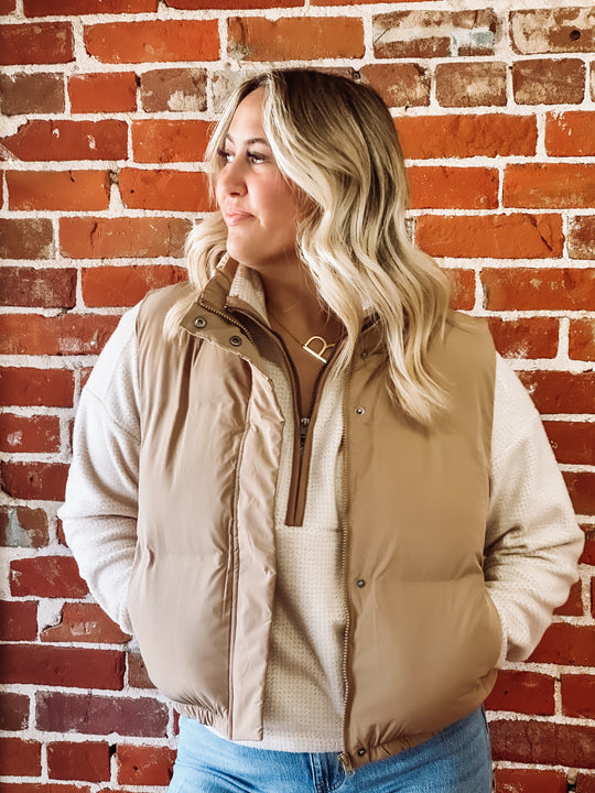 Tan vest layered over a cream colored pullover