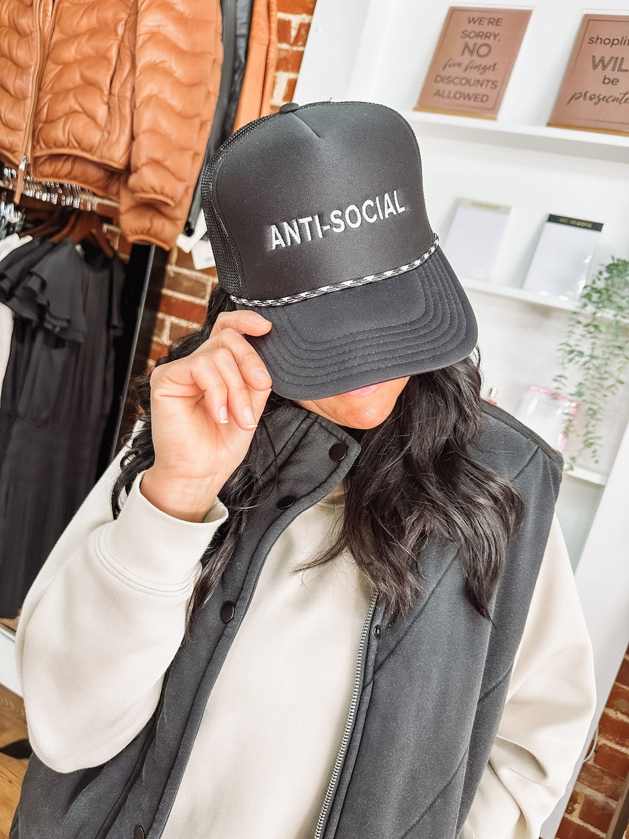 black trucker hat with "anti-social" embroidered