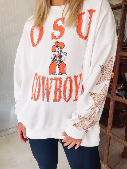 white crewneck sweatshirt with OSU Cowboys typography and star studded rhinestones on the sleeves