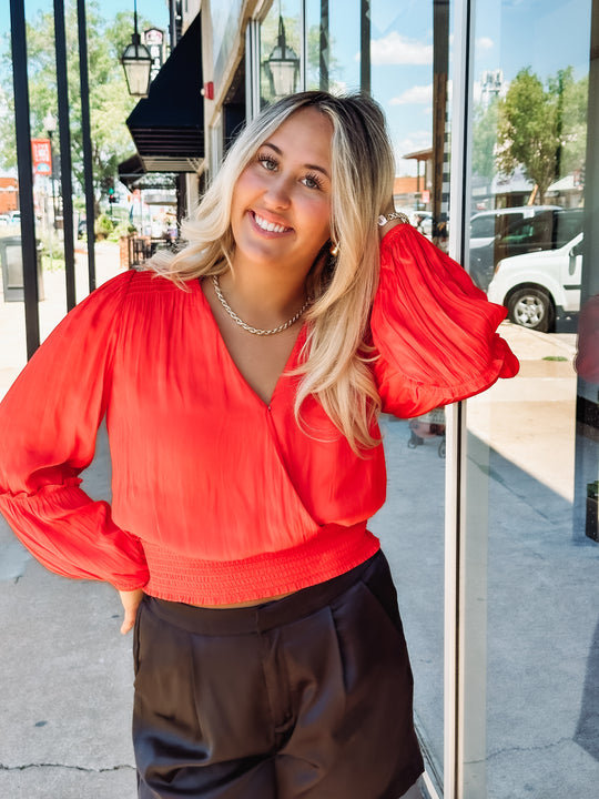 Orange colored long sleeve blouse