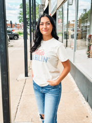 Graphic tee with vintage typography featuring "Hello Darlin'" in a blue and red color way.