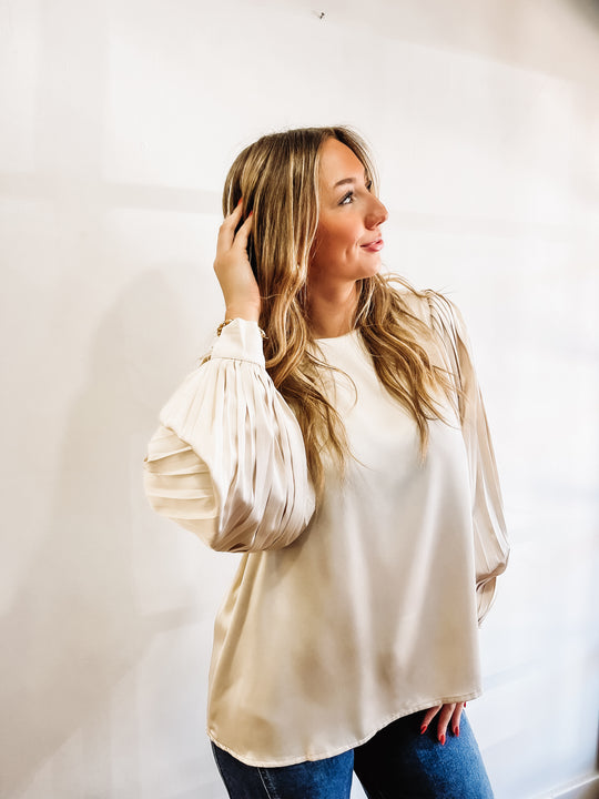 Champagne colored pleated long cuff sleeve blouse