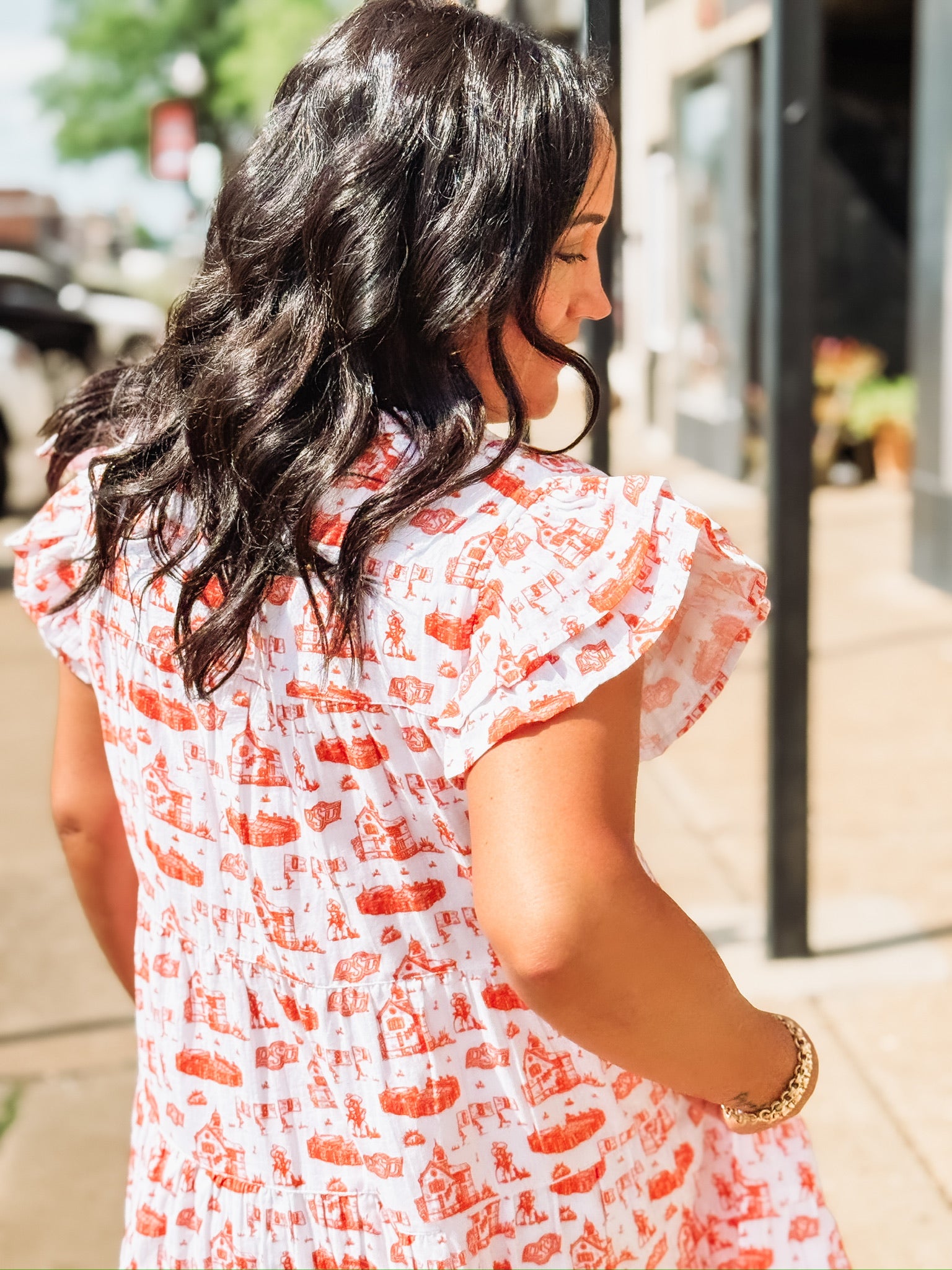 Orange and white OSU-themed toile dress with flutter sleeves, featuring a fitted waist and flowy silhouette.