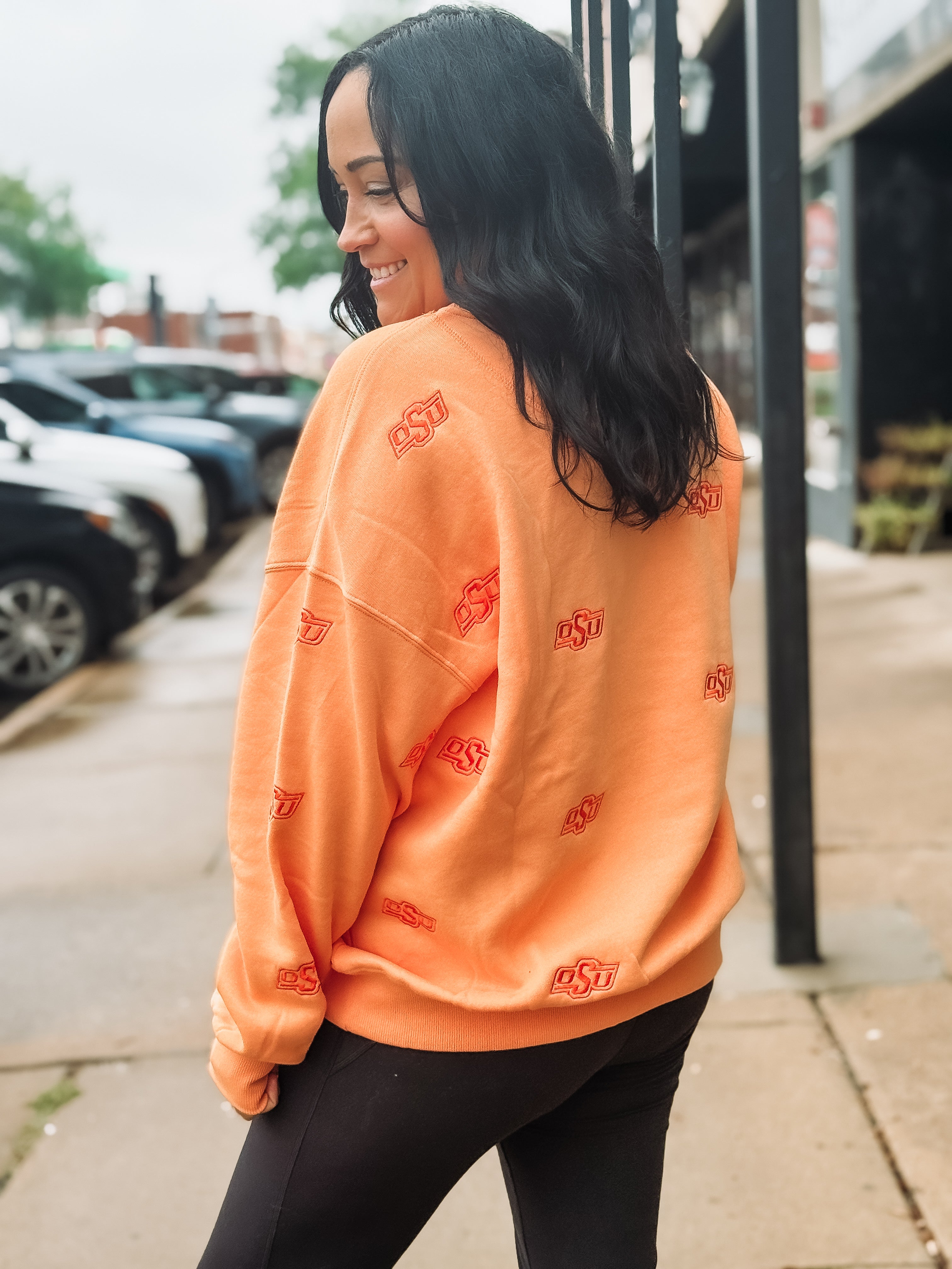 Sherbert orange Oklahoma State long sleeve crew neck with embroidered OSU logo in a slightly darker orange.