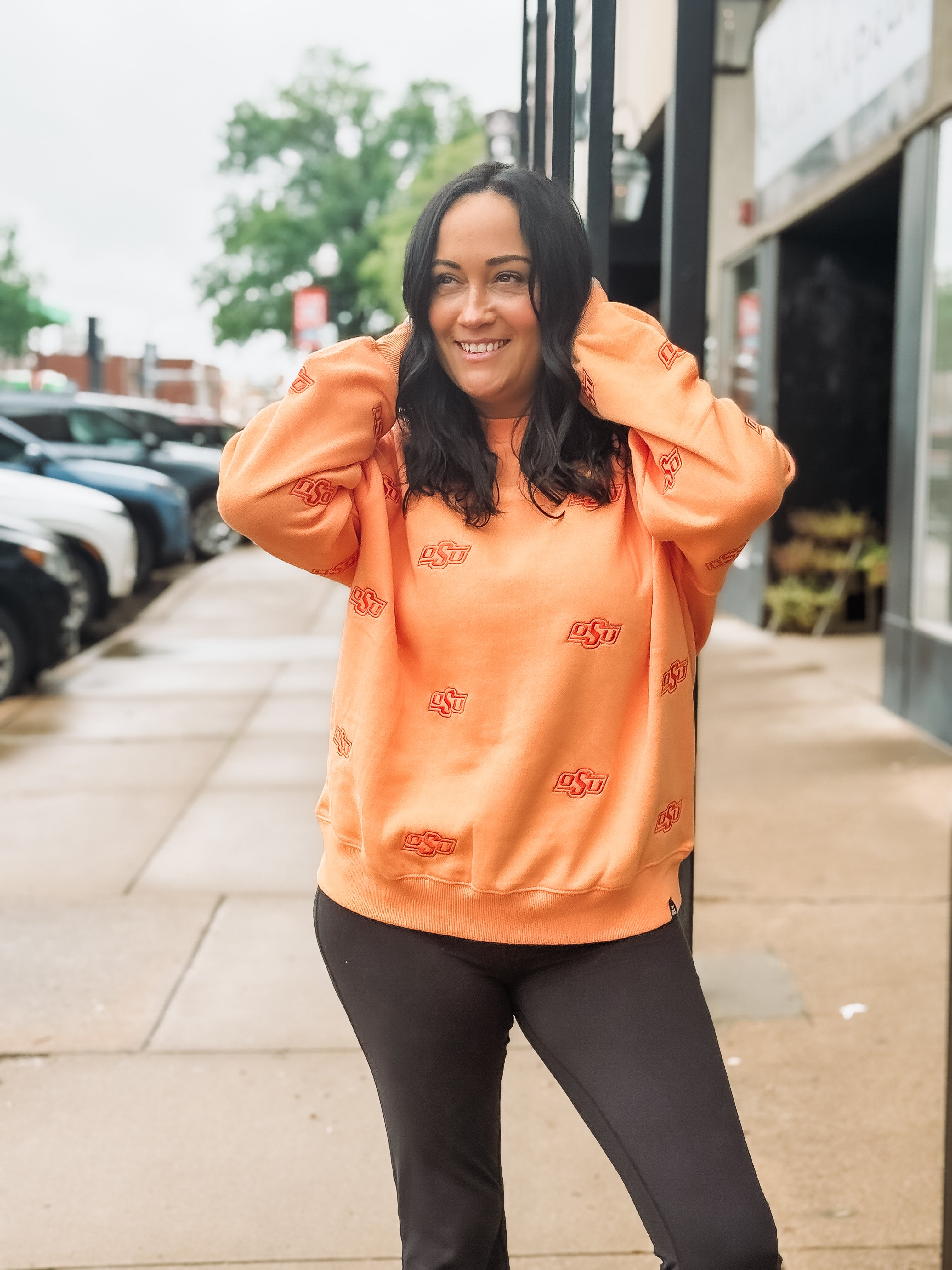 Sherbert orange Oklahoma State long sleeve crew neck with embroidered OSU logo in a slightly darker orange.