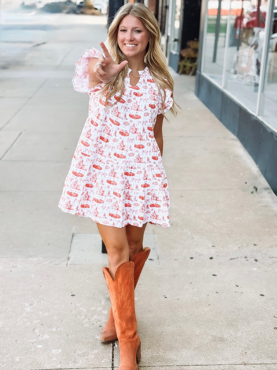 Orange and white OSU-themed toile dress with flutter sleeves, featuring a fitted waist and flowy silhouette.