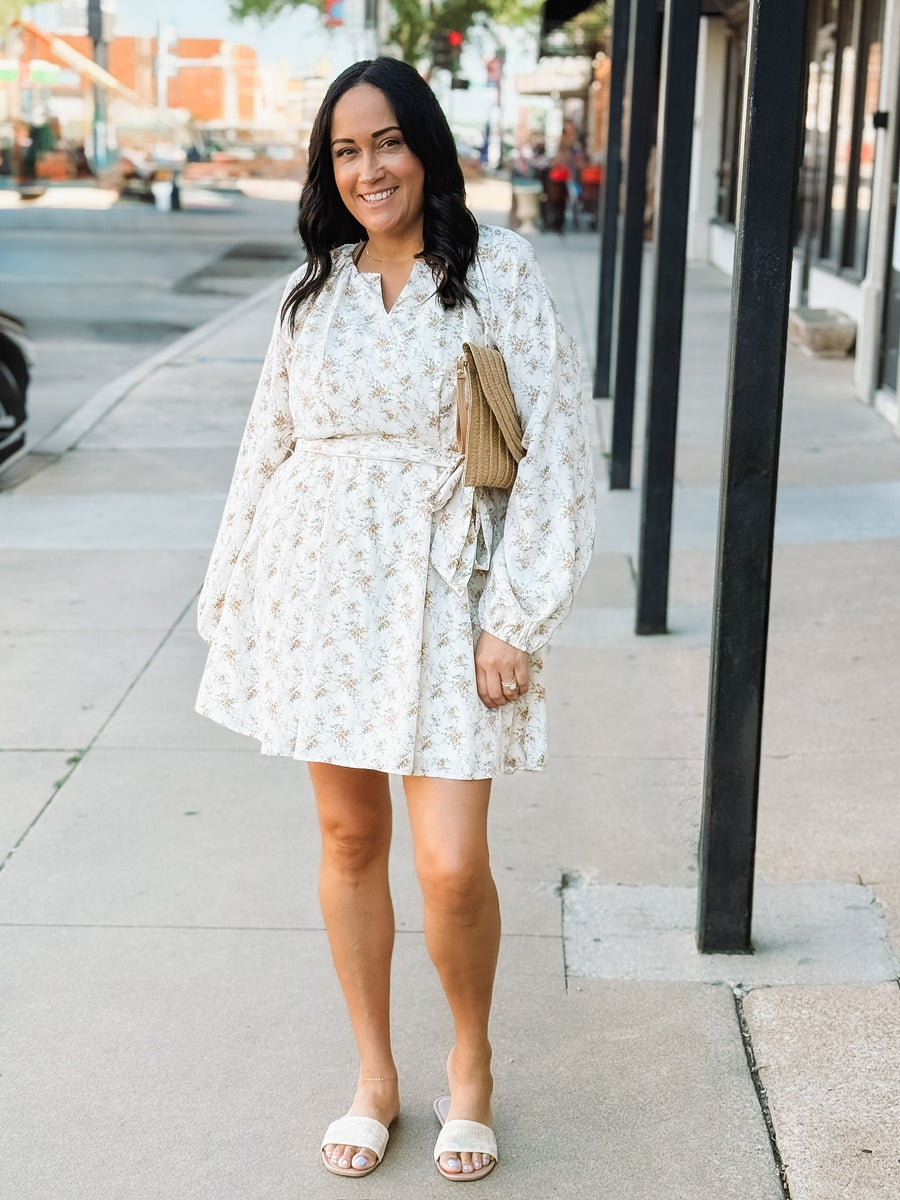 Yellow floral on a cream base long sleeve  tie waist long sleeve mini dress.