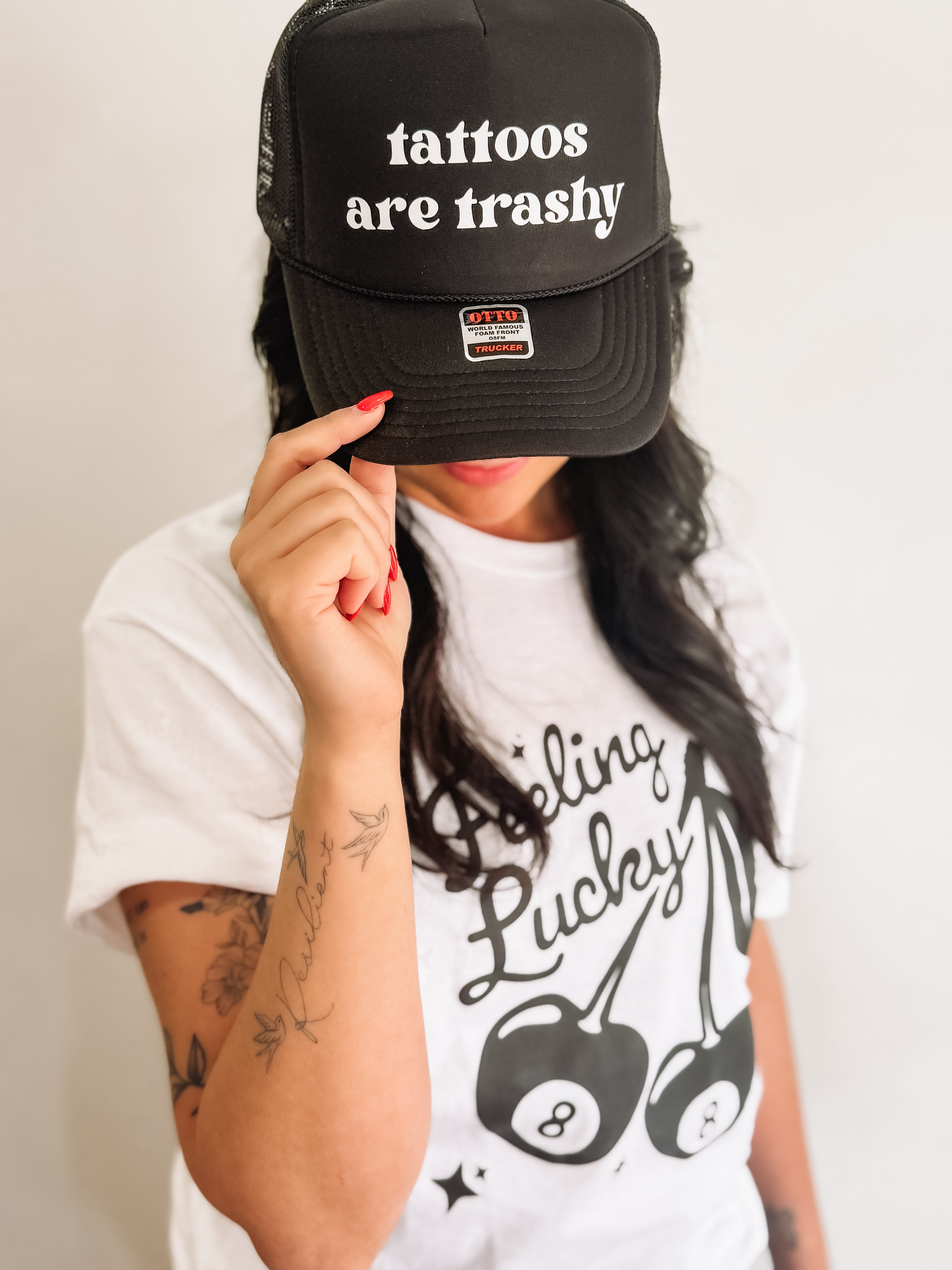 tattoos are trashy, printed on a black Otto trucker hat.