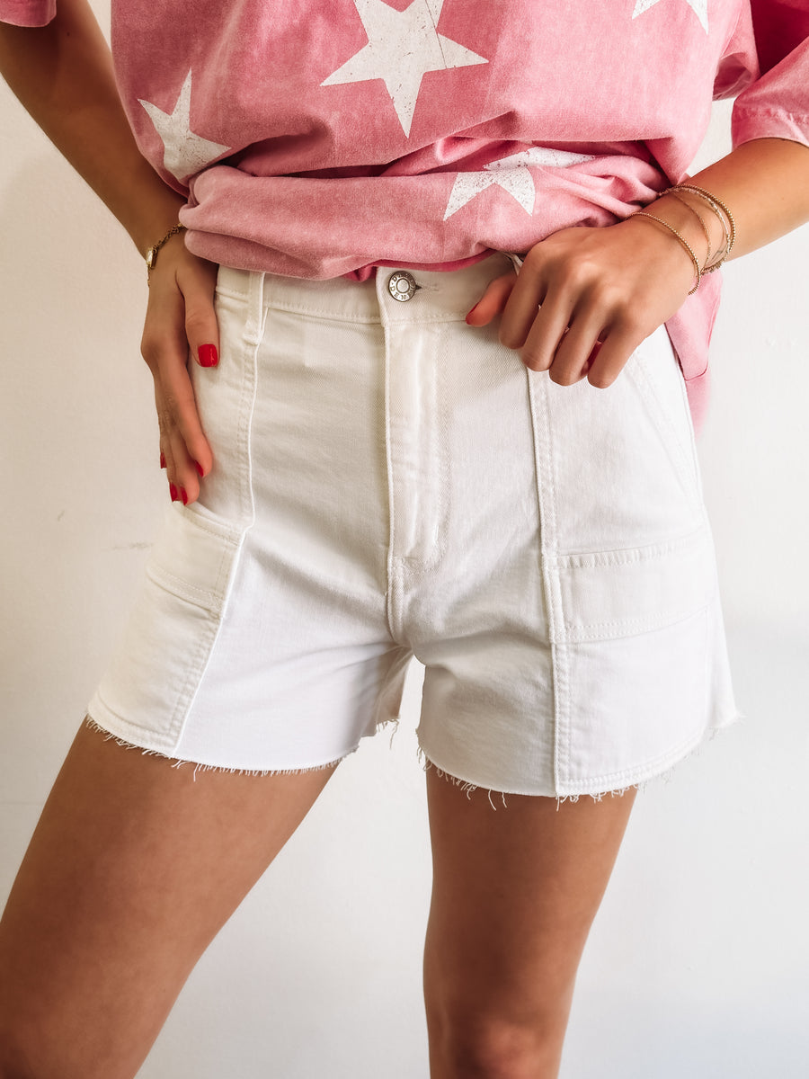 White cargo denim shorts with raw hem by Daze.
