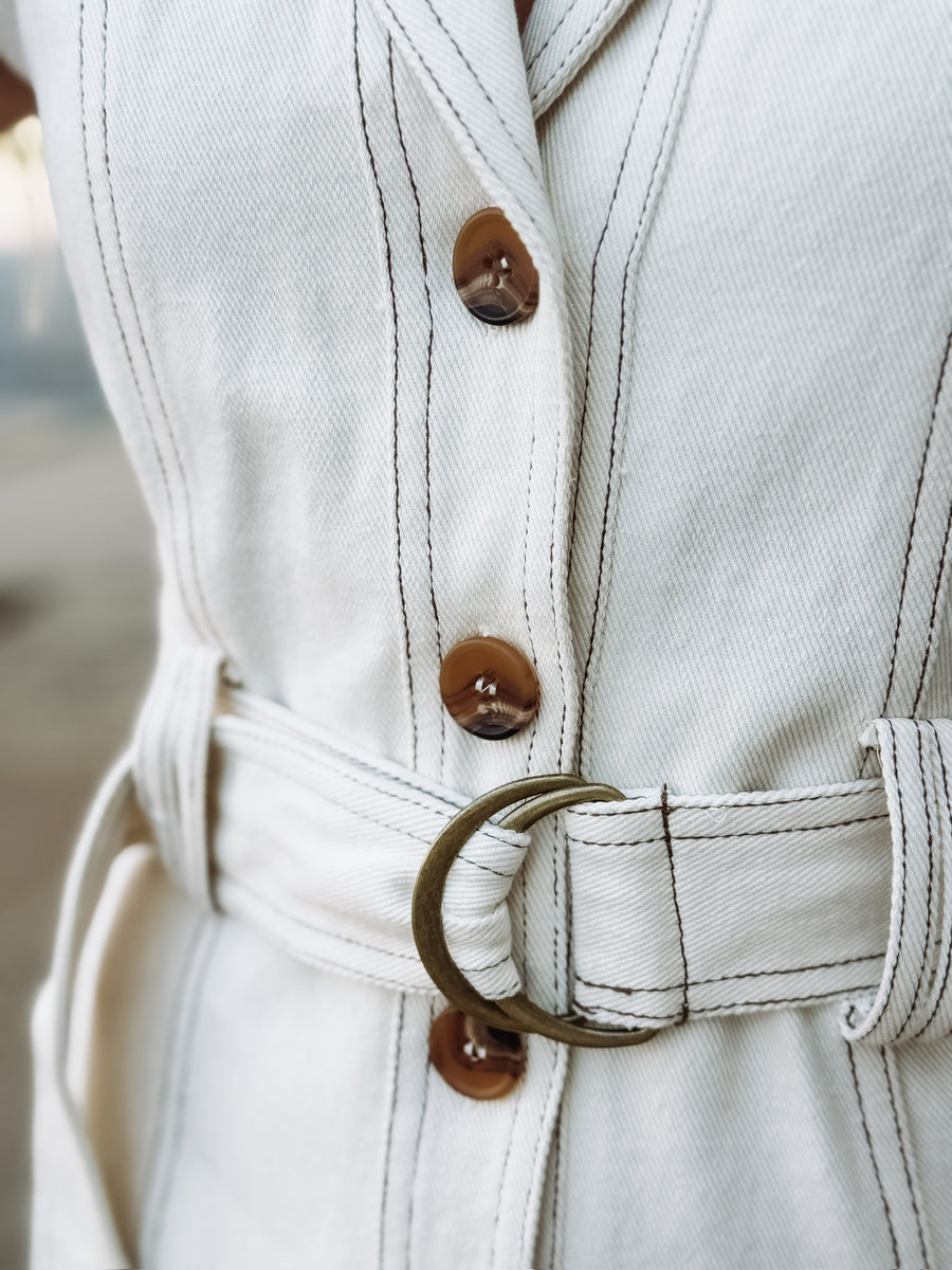Cream button up sleeveless denim mini dress with d ring belt detail.