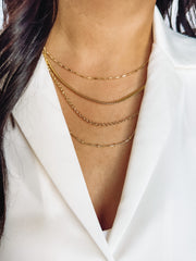 four gold necklaces in one